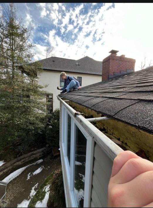 Will and Phil cleaning gutters on an Arlington home